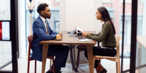 Colleagues talking at a table