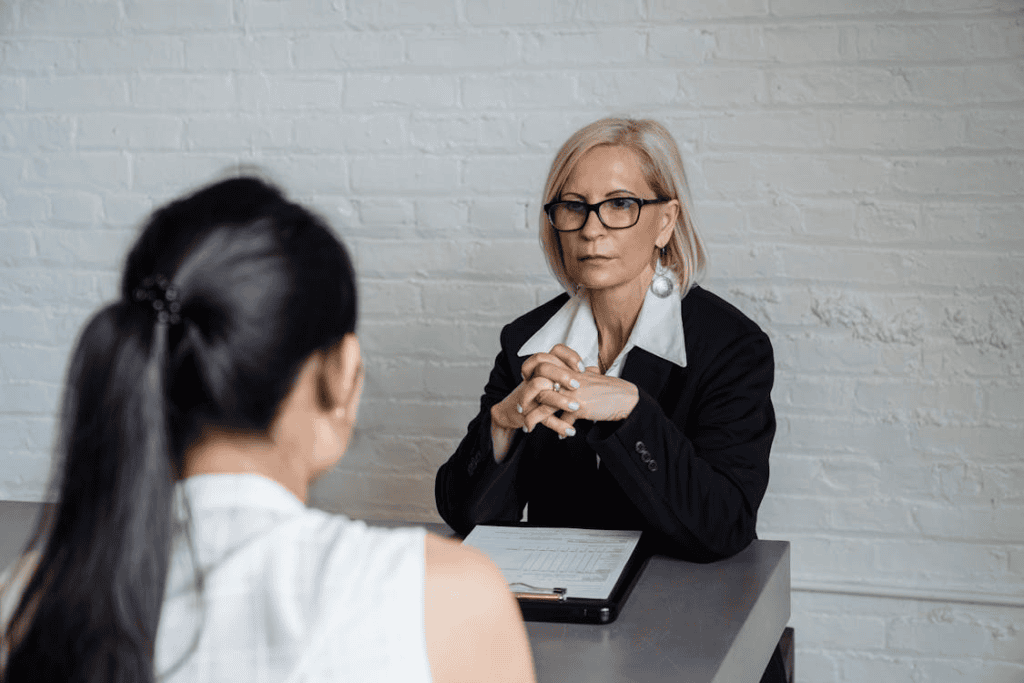 blonde woman sitting with her hands together