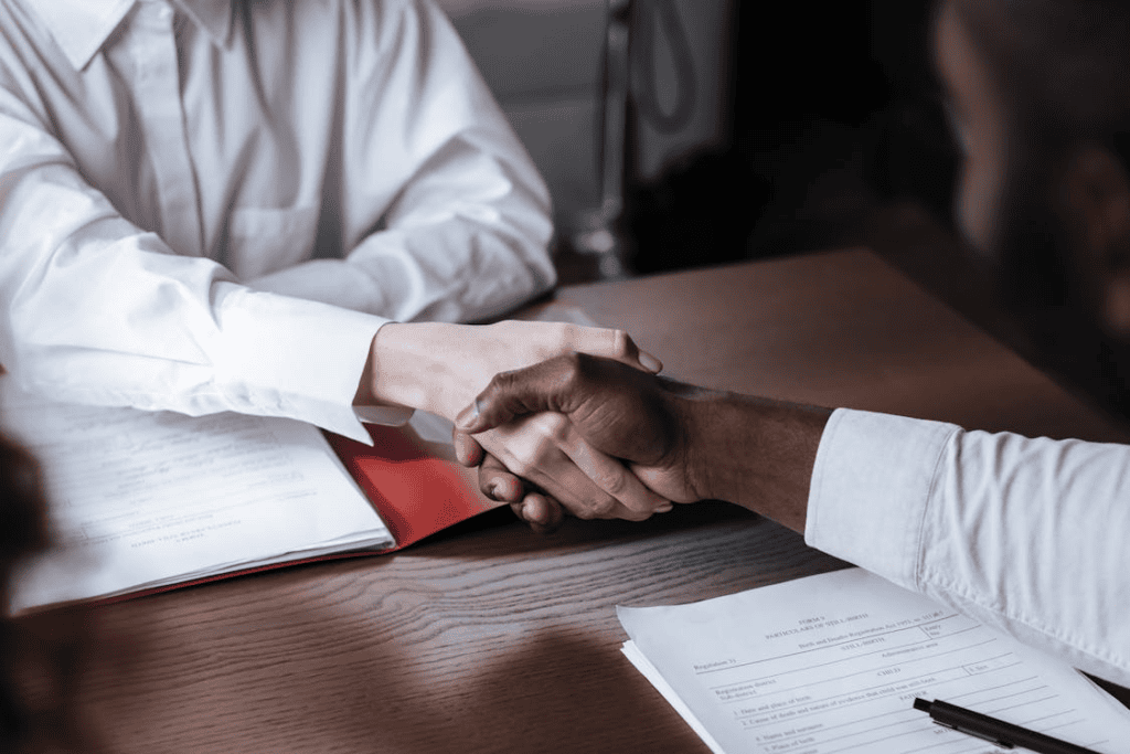 A recruiter shaking hands with a legal professional after a successful job placement